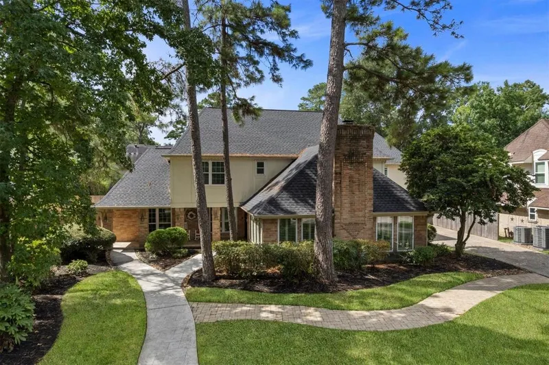 Front exterior and mature trees at 9527 Enstone Circle